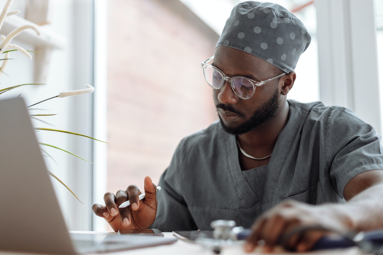 Physician looking at his laptop | Dr.Bill